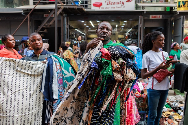 A Man Waits For Costumers While Selling Clothes At The Balogun Market In Lagos On December 18 2023 1