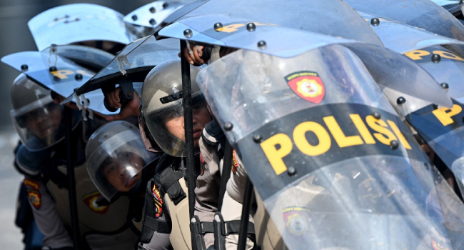 Police Hold Positions Behind Their Shields During A Demonstration In Front Of The Bali Police Station In Denpasar Indonesia