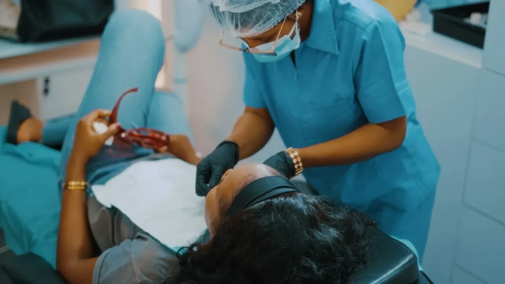 Woman Geting Her Mouth Checked By A Dentist