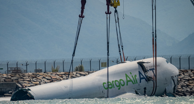 A Crane Hoists The Recovered Fuselage Section Of An Act Airlines Boeing 747 400 Cargo Aircraft A Crane Hoists The Recovered Fuselage Section Of An Act Airlines Boeing 747 400 Cargo Aircraft
