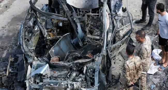 Lebanese Security Forces Inspect A Destroyed Car Targeted In An Israeli Drone Attack