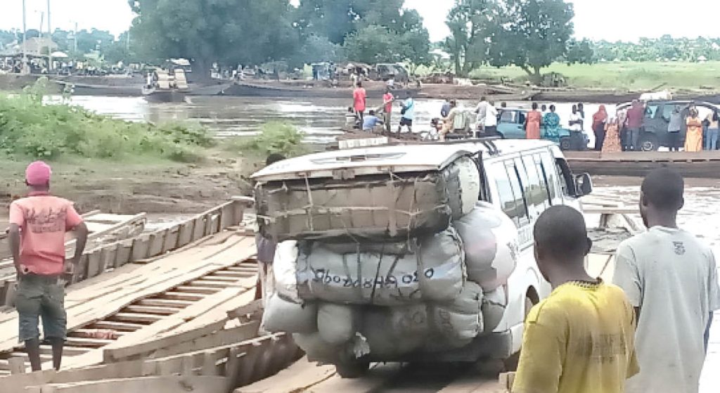 Vehicles And Passengers Inside Ferries On Namnai River Near The Collapsed Namnai Bridge In Taraba State