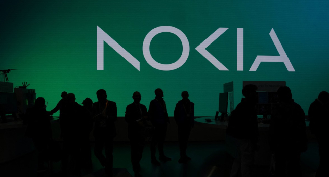 Visitors Walk Past The Logo Of Finnish Multinational Telecommunications Nokia During The Mobile World Congress
