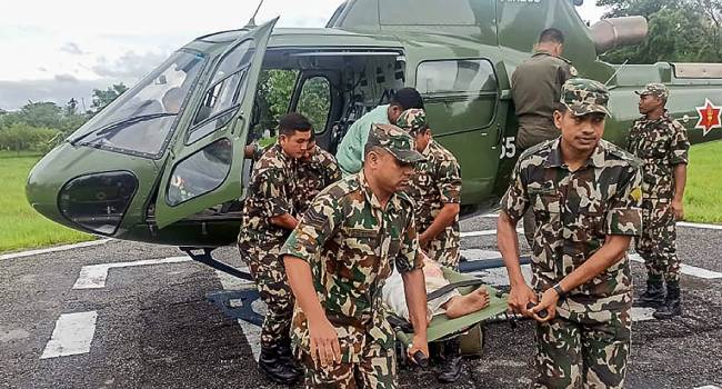 Photograph Taken And Released By Nepals Army On October 5 2025 Shows Army Personnel Carrying A Landslide Victim Evacuated