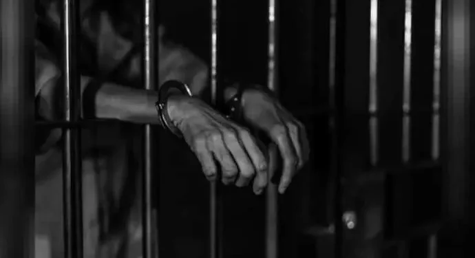 Prisoner Behind Bars Handcuffed 161419374 16X9 0 690X375 1 Prisoner Behind Bars Handcuffed 161419374 16X9 0 690X375 1