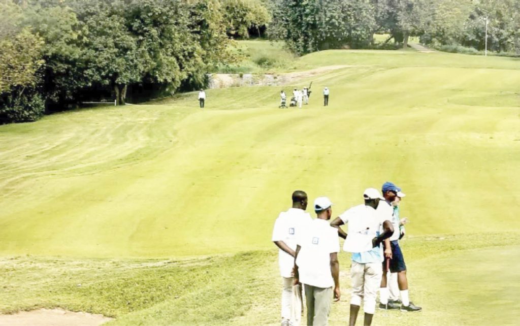Some Golfers With Their Caddies One Of The Holes Of The Ibb Golf Club Course