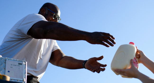 Man Receives A Jar Of Milk Man Receives A Jar Of Milk