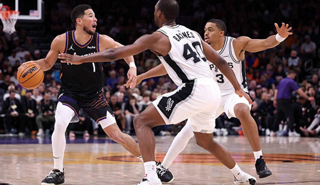 Phoenix Arizona Devin Booker Of The Phoenix Suns Dribbles The Ball Against Keldon Johnson And