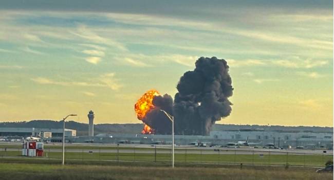 Smoke And Flames Rising From The Site Of A Ups Cargo Plane Crash Outside Louisville International Airport